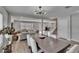 Open-concept living and dining area with modern lighting, neutral walls, and wood-look floors, ideal for entertaining at 7116 Cruz Ct, Lakeland, FL 33813