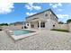 A charming backyard pool with a cozy patio, surrounded by lush greenery and white gravel at 7116 Cruz Ct, Lakeland, FL 33813