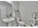 Modern powder room with a pedestal sink, neutral paint, and minimalist decor providing a clean, fresh look at 7116 Cruz Ct, Lakeland, FL 33813
