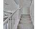 Carpeted staircase with white railings leads to the second floor of the house at 7116 Cruz Ct, Lakeland, FL 33813