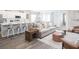 Open-concept living room and kitchen featuring hardwood floors and neutral decor at 7501 Sw 107Th Ln, Ocala, FL 34476