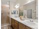 Well-lit bathroom with double vanity, updated fixtures, and glass-enclosed shower at 7515 Sw 107Th Ln, Ocala, FL 34476