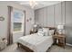 Cozy bedroom with plush carpet, soft lighting, and window with view of green landscape at 7515 Sw 107Th Ln, Ocala, FL 34476