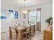Dining room with hardwood floors, modern chandelier, and a six-chair dining table at 7515 Sw 107Th Ln, Ocala, FL 34476