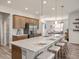 Bright kitchen featuring an island with seating, stainless steel refrigerator, and stylish decor at 7515 Sw 107Th Ln, Ocala, FL 34476