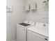 Functional laundry room equipped with a new washer, dryer, and ample storage shelving at 7515 Sw 107Th Ln, Ocala, FL 34476