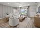 Bright living room features modern decor, neutral color palette, and sliding glass doors to the outdoor patio at 7515 Sw 107Th Ln, Ocala, FL 34476