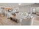 Open-concept living space featuring modern furniture and a view into the kitchen at 7515 Sw 107Th Ln, Ocala, FL 34476
