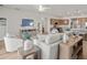 Open-concept living room with hardwood floors, modern furnishings, and seamless flow into the kitchen at 7515 Sw 107Th Ln, Ocala, FL 34476