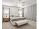 Relaxing bedroom with decorative wall paneling, neutral tones, large windows and ceiling fan at 7515 Sw 107Th Ln, Ocala, FL 34476