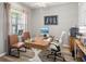 Home office featuring hardwood floors, a wooden desk, and comfortable seating at 7515 Sw 107Th Ln, Ocala, FL 34476