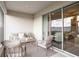 Enclosed patio area with comfortable seating arrangement, and sliding glass doors at 7515 Sw 107Th Ln, Ocala, FL 34476