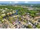 Aerial view showcases the neighborhood, landscaping, and surrounding area at 8818 Tottenham Way, Kissimmee, FL 34747