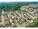 An aerial shot shows a lovely neighborhood with many homes featuring private pools and verdant landscaping at 8818 Tottenham Way, Kissimmee, FL 34747
