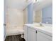Bathroom boasts a vanity, black floors, and a shower over the tub at 8818 Tottenham Way, Kissimmee, FL 34747