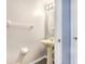 Half-bathroom with tile flooring, sink, oval mirror and towel rack at 8818 Tottenham Way, Kissimmee, FL 34747