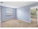 Spacious carpeted bedroom with window and adjacent access to second bedroom at 8818 Tottenham Way, Kissimmee, FL 34747