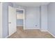 Neutral bedroom featuring an open doorway, neutral carpet, and light blue painted walls at 8818 Tottenham Way, Kissimmee, FL 34747