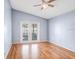 Bedroom with wood floors, double doors to lanai, and plenty of natural light at 8818 Tottenham Way, Kissimmee, FL 34747