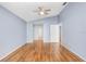 Light-filled bedroom with light blue walls and wood-look flooring and a ceiling fan at 8818 Tottenham Way, Kissimmee, FL 34747