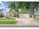 Charming single-Gathering home with a two-car garage, a manicured lawn, and mature trees at 8818 Tottenham Way, Kissimmee, FL 34747