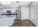 Kitchen area features stainless steel refrigerator, white cabinets, and eat in nook at 8818 Tottenham Way, Kissimmee, FL 34747