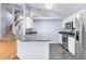 Bright kitchen with stainless steel appliances, granite countertops, and herringbone floors at 8818 Tottenham Way, Kissimmee, FL 34747