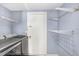 Laundry room with updated washer and dryer and wire rack shelving at 8818 Tottenham Way, Kissimmee, FL 34747
