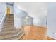 Bright living room with vaulted ceilings, wood floors, large windows, and staircase at 8818 Tottenham Way, Kissimmee, FL 34747