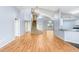 Open-concept living room with wood floors, vaulted ceiling, staircase and kitchen area at 8818 Tottenham Way, Kissimmee, FL 34747