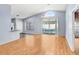 Spacious living area with wood floors, view of pool, slider doors and modern light fixture at 8818 Tottenham Way, Kissimmee, FL 34747