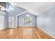 Bright living room with wood floors, large windows, high ceilings, and a neutral color palette at 8818 Tottenham Way, Kissimmee, FL 34747