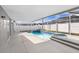 Backyard features a swimming pool, attached spa, screened enclosure, covered patio, and deck at 8818 Tottenham Way, Kissimmee, FL 34747
