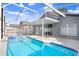 Backyard swimming pool with attached spa, screened enclosure, covered patio, and deck at 8818 Tottenham Way, Kissimmee, FL 34747