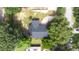 Aerial shot of a home with a lush, green yard and mature trees at 910 Van Dr, Auburndale, FL 33823