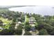 A picturesque street view with mature trees leading to a serene lake at 910 Van Dr, Auburndale, FL 33823