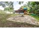 Spacious backyard featuring a playset, fire pit, and ample space for outdoor activities at 910 Van Dr, Auburndale, FL 33823