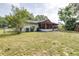 The backyard boasts a huge lawn and a screened in porch at 910 Van Dr, Auburndale, FL 33823