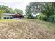 Large backyard featuring lush greenery and a playset at 910 Van Dr, Auburndale, FL 33823