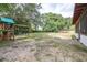 Large, open backyard with a playset and plenty of room for recreation at 910 Van Dr, Auburndale, FL 33823