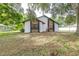 Spacious backyard featuring lush greenery and mature trees, offering a serene outdoor space at 910 Van Dr, Auburndale, FL 33823
