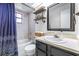 Updated bathroom features a shower-tub combo and modern finishes at 910 Van Dr, Auburndale, FL 33823