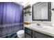Updated bathroom features a shower-tub combo and modern finishes at 910 Van Dr, Auburndale, FL 33823