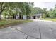 Charming home featuring stone accents, dark grey garage door, and a well-maintained front yard at 910 Van Dr, Auburndale, FL 33823