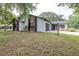 Charming home featuring stone accents, dark grey garage door, and a well-maintained front yard at 910 Van Dr, Auburndale, FL 33823