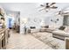 Bright living room with an oversized sectional, modern ceiling fans, and stylish decor at 910 Van Dr, Auburndale, FL 33823