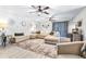 Bright living room with an oversized sectional, modern ceiling fans, and stylish decor at 910 Van Dr, Auburndale, FL 33823