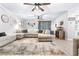 Spacious living room features a large sectional, wood-look floors, and updated ceiling fans at 910 Van Dr, Auburndale, FL 33823