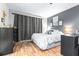 This bedroom has a comfortable bed, blackout curtains, and stylish decor at 910 Van Dr, Auburndale, FL 33823