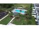 Aerial view of a community pool with lounge chairs, playground, and landscaped features at 943 Grandin St, Davenport, FL 33837